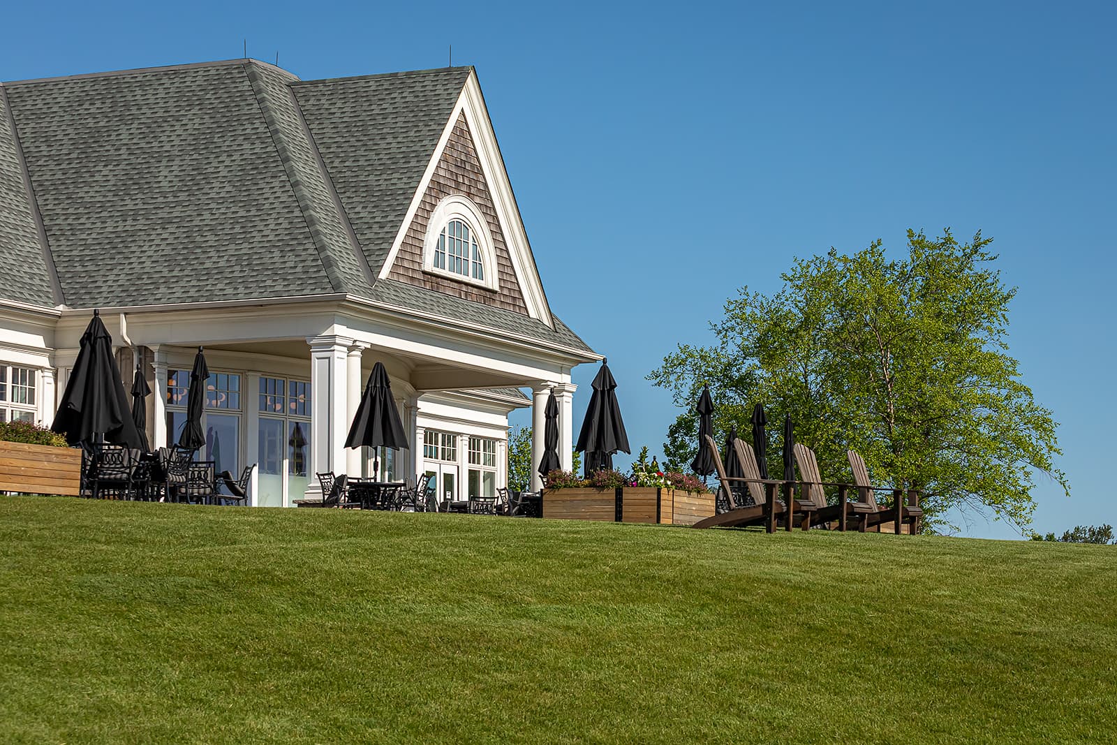 golf course clubhouse and 3 Adirondack chairs
