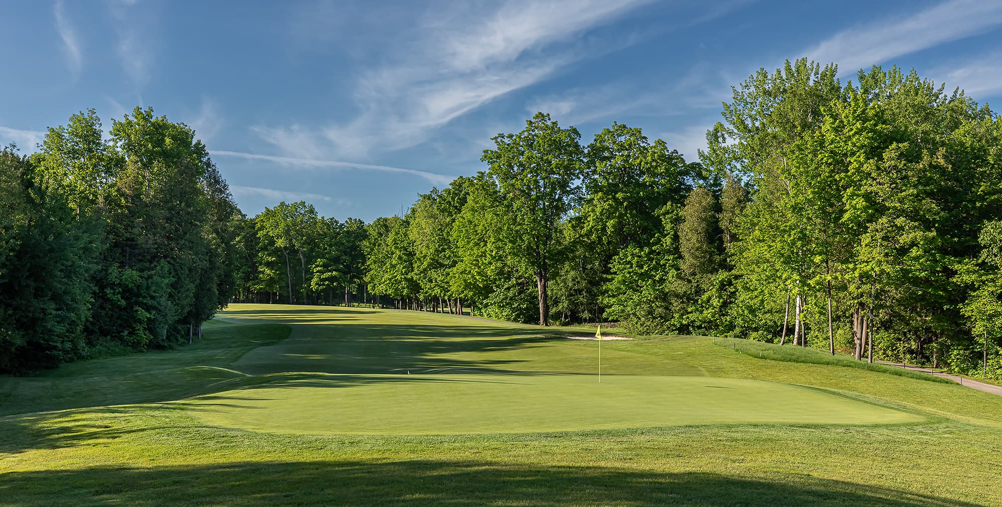 Southern Ontario golf course fairway with trees and putting green