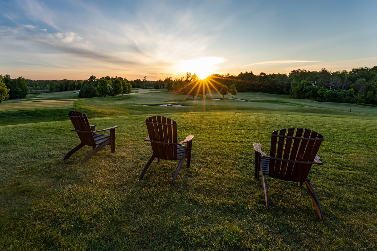 golf course sunset view with Adirondack chairs overlooking fairway in Southern Ontario