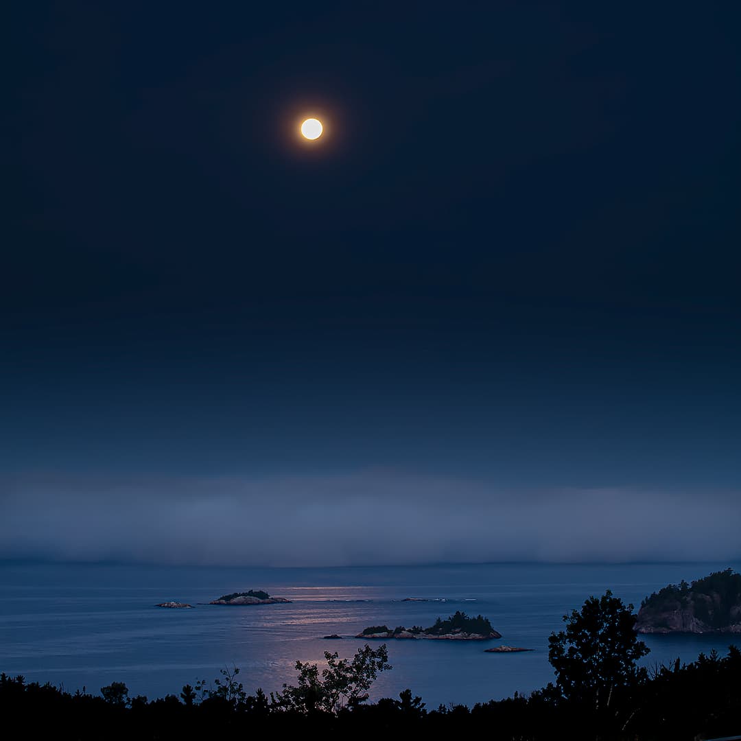 Fog rolling into Agawa Bay under a full moon.