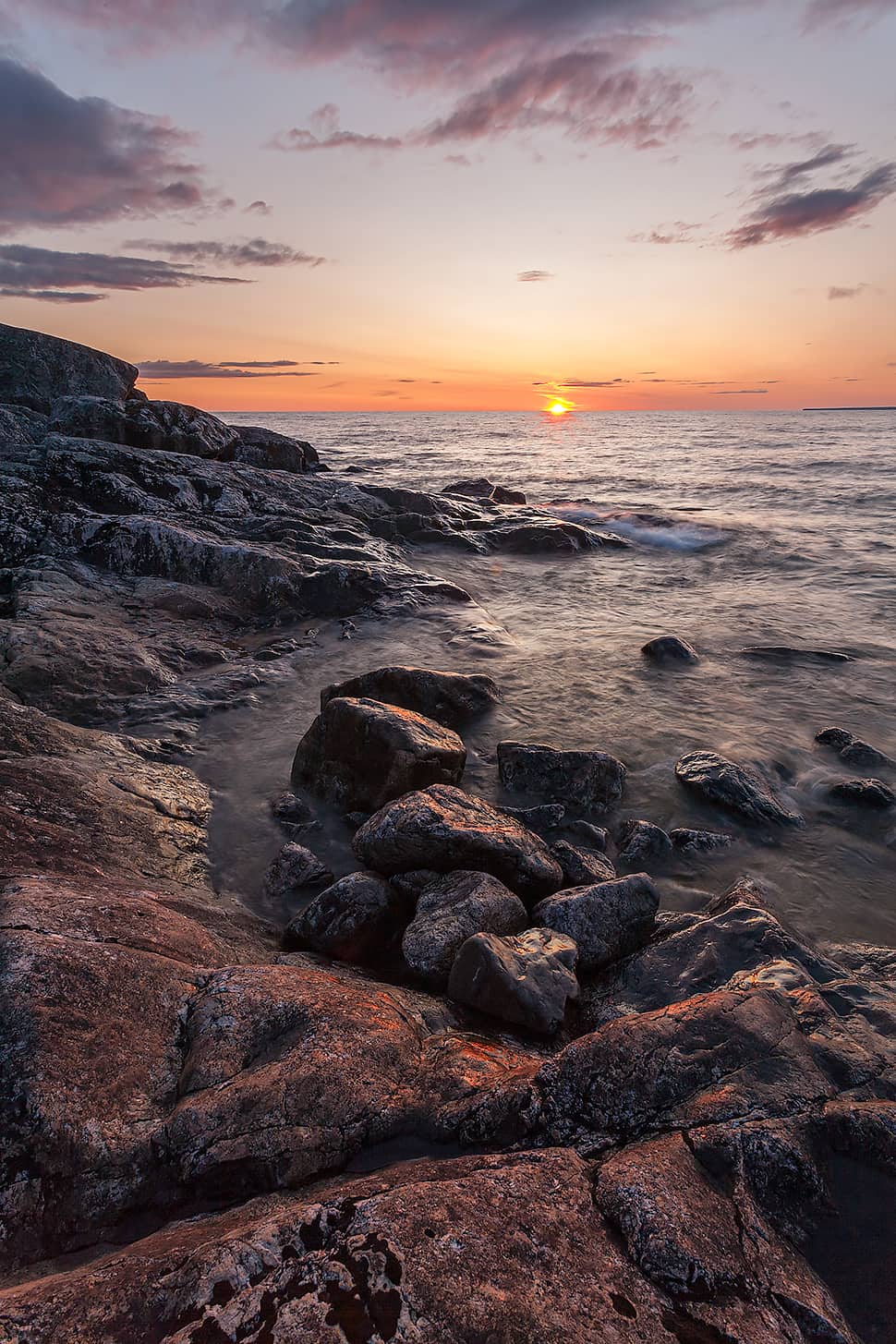 sunset and rocky shoreline over Lake Superior