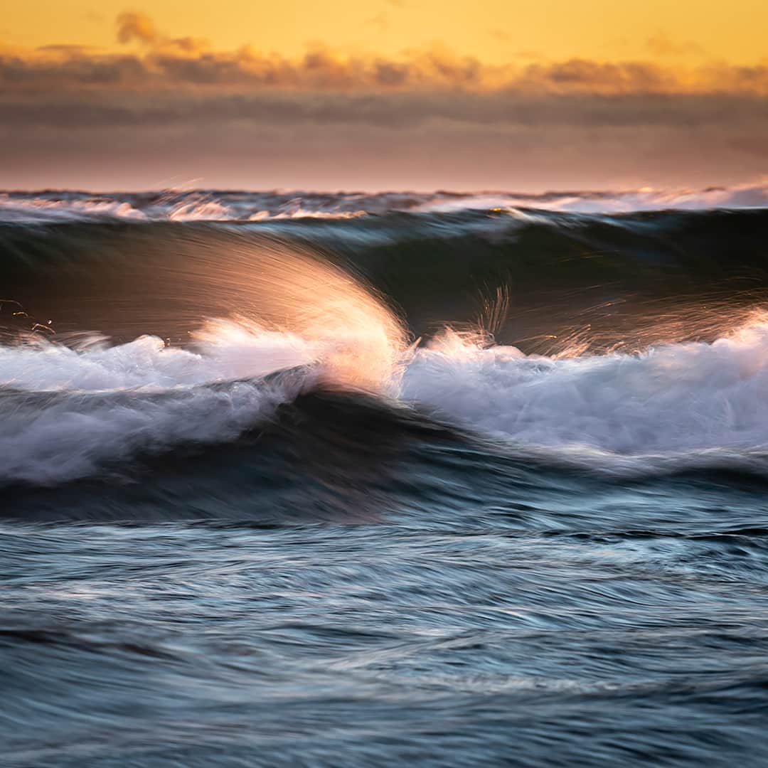 Spray from a wave on Lake Superior during golden hour