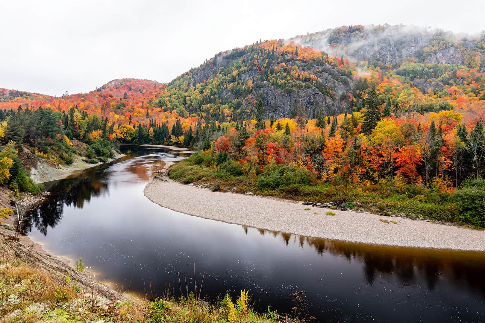 calm river reflections with beautiful fall colour and fog