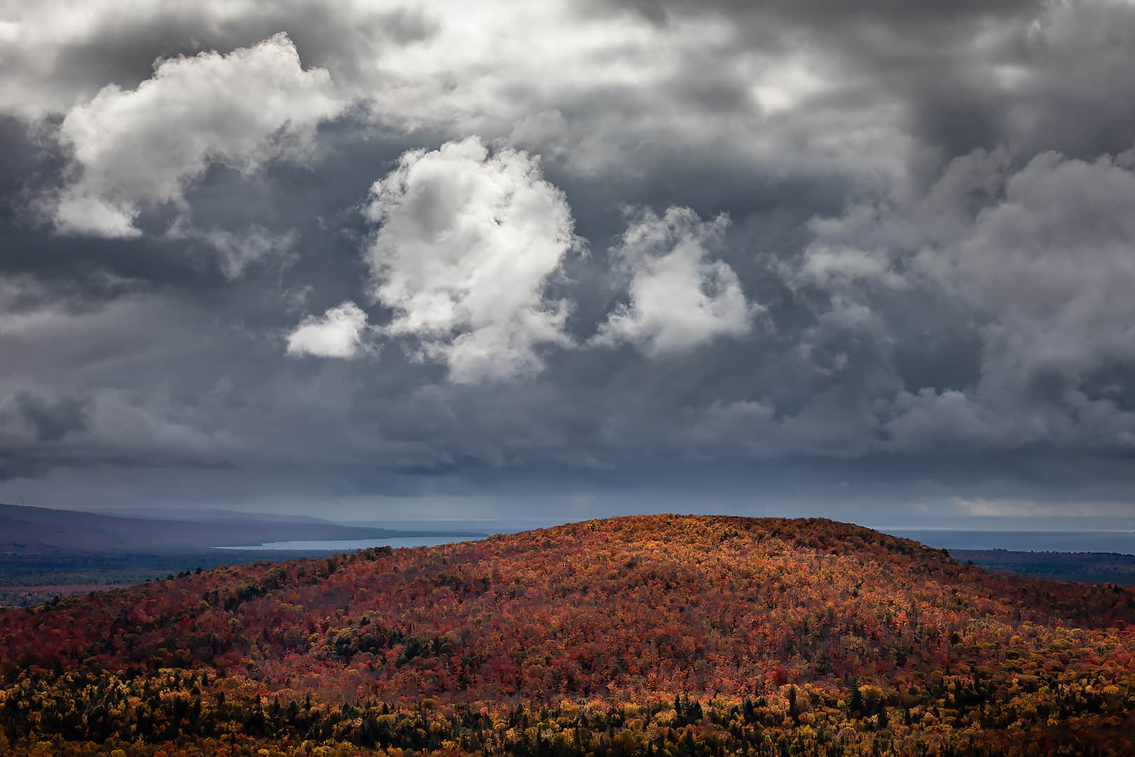 autumn hilltop with dramatic light and stormy sky