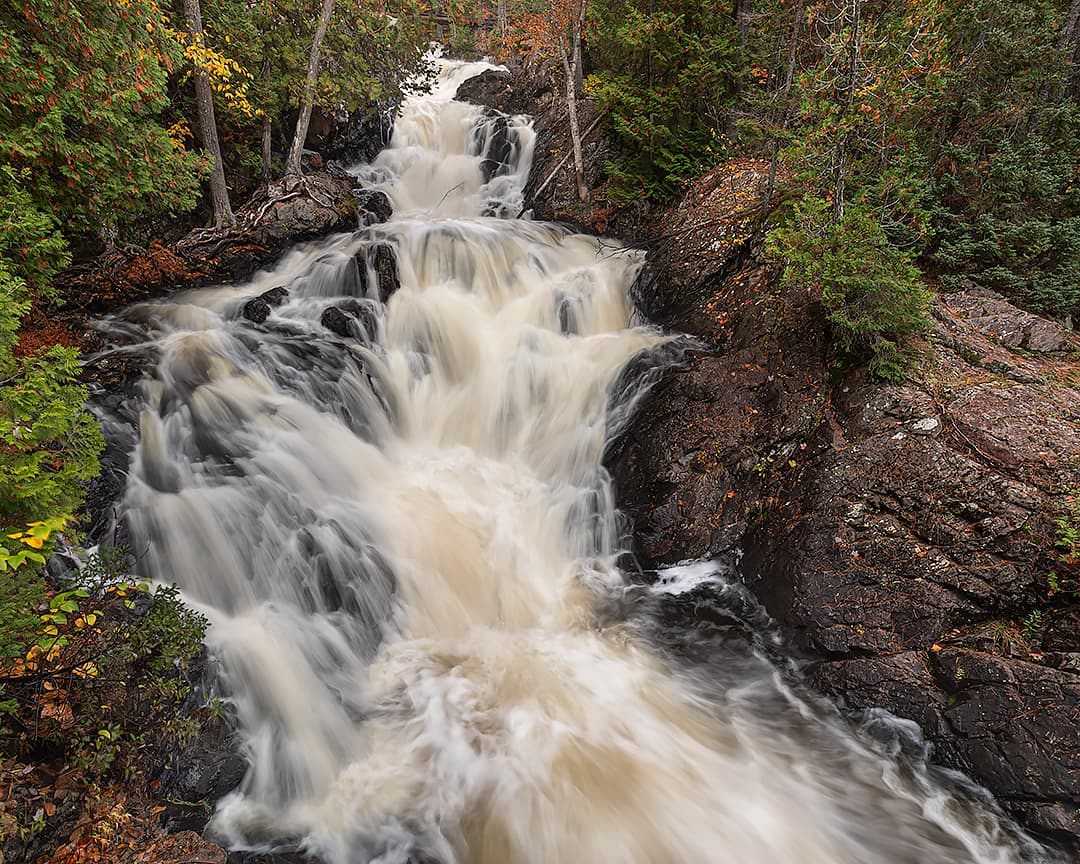 large waterfall with heavy flow