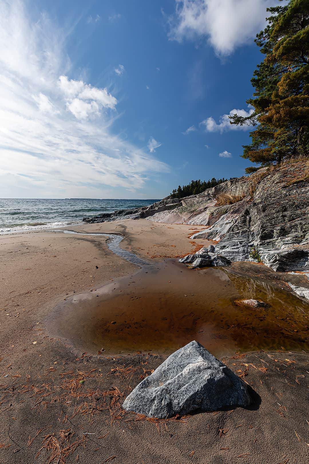 Sandy beach and rocky Lake Superior shoreline north of the Barrett River.