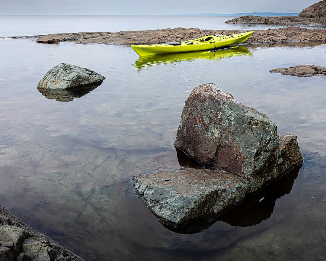 yellow kayak on rocky shoreline of Lake Superior