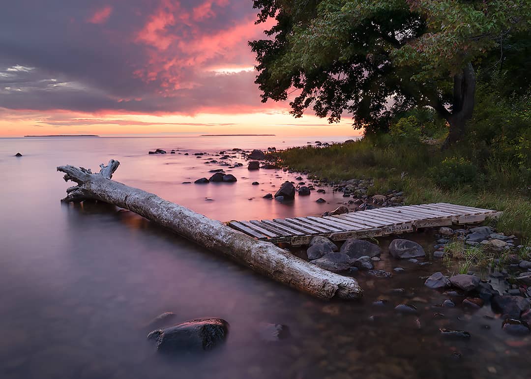 sun setting over island in Lake Superior