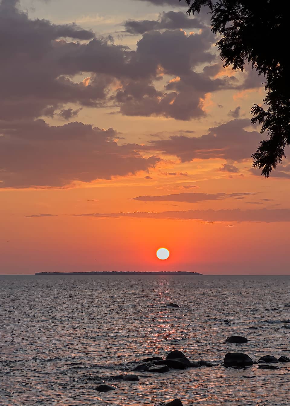 sun setting over island in Lake Superior