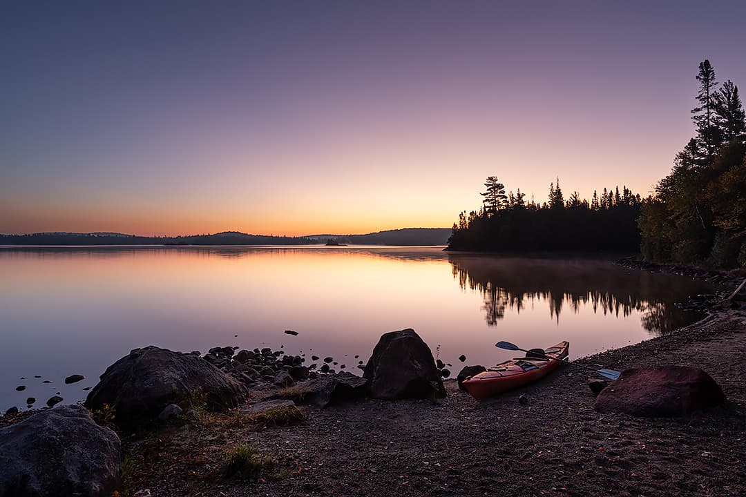 kayak on a beach at sunrise